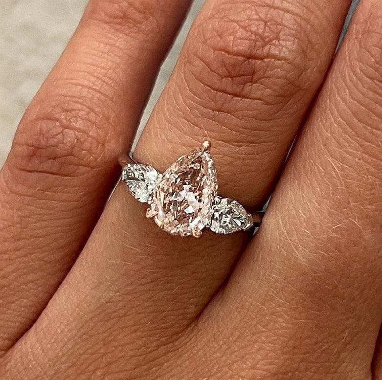 2.70 Carat Pear Cut Fancy Intense Pink Lab Grown Diamond Three Stone Ring
